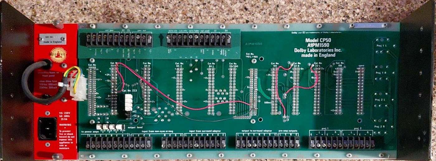 Interior of a Dolby CP50 cinema processor showing the motherboard and modular circuit-card positions.